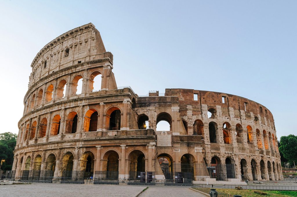 Exterior view of the Colosseum in Rome, Italy, showing its ancient stone arches and Roman architecture.