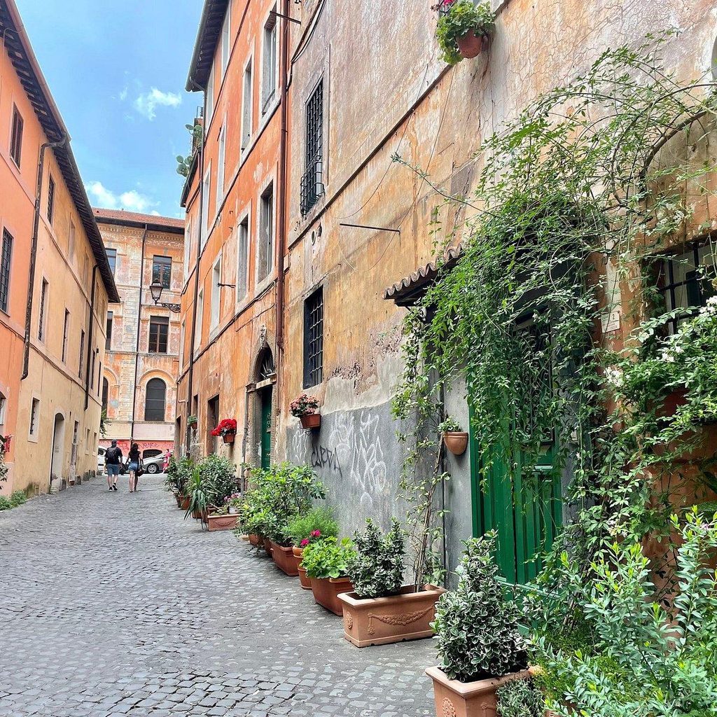 Charming cobblestone street in Rome, Italy, lined with historic buildings and traditional architecture.
