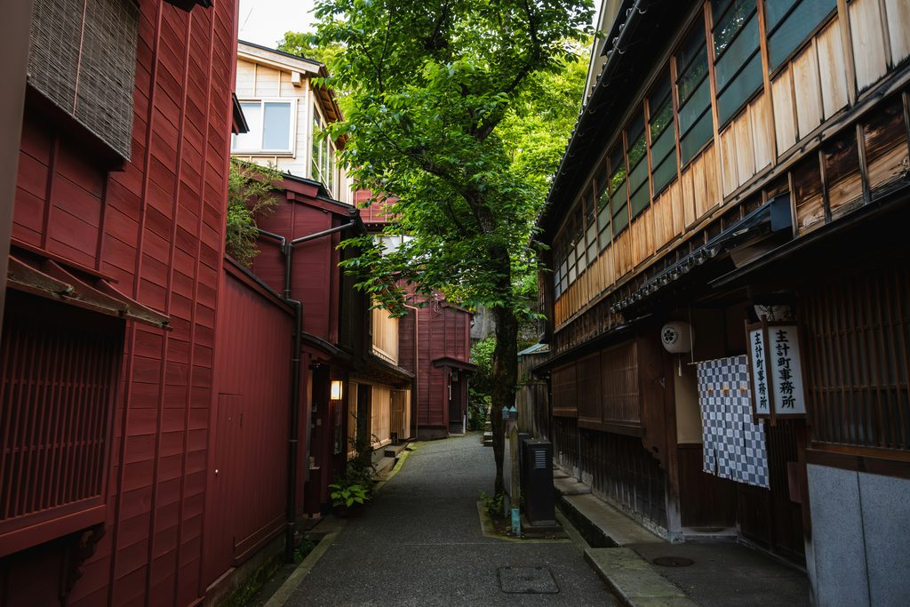 Traditional wooden buildings lining a narrow, quiet street in Kanazawa’s historic Higashi Chaya District, Japan.